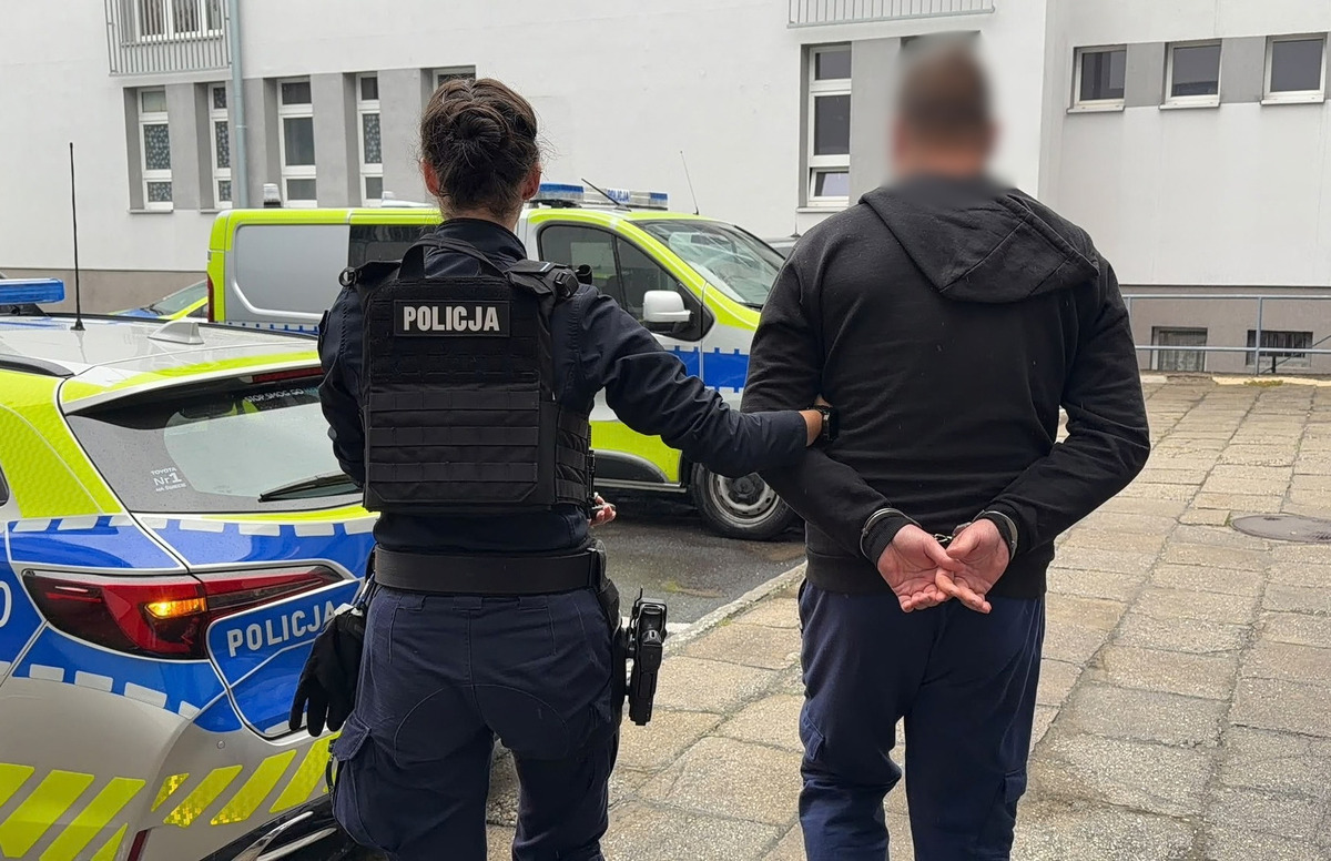zdjęcie: policjantka z zatrzymanym mężczyzną 