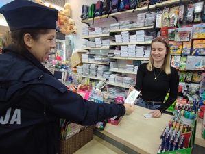 na zdjęciu policjantka wręcza zawieszki pracownicy sklepu