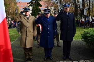 przedstawiciele służb mundurowych składający kwiaty pod pomnikiem
